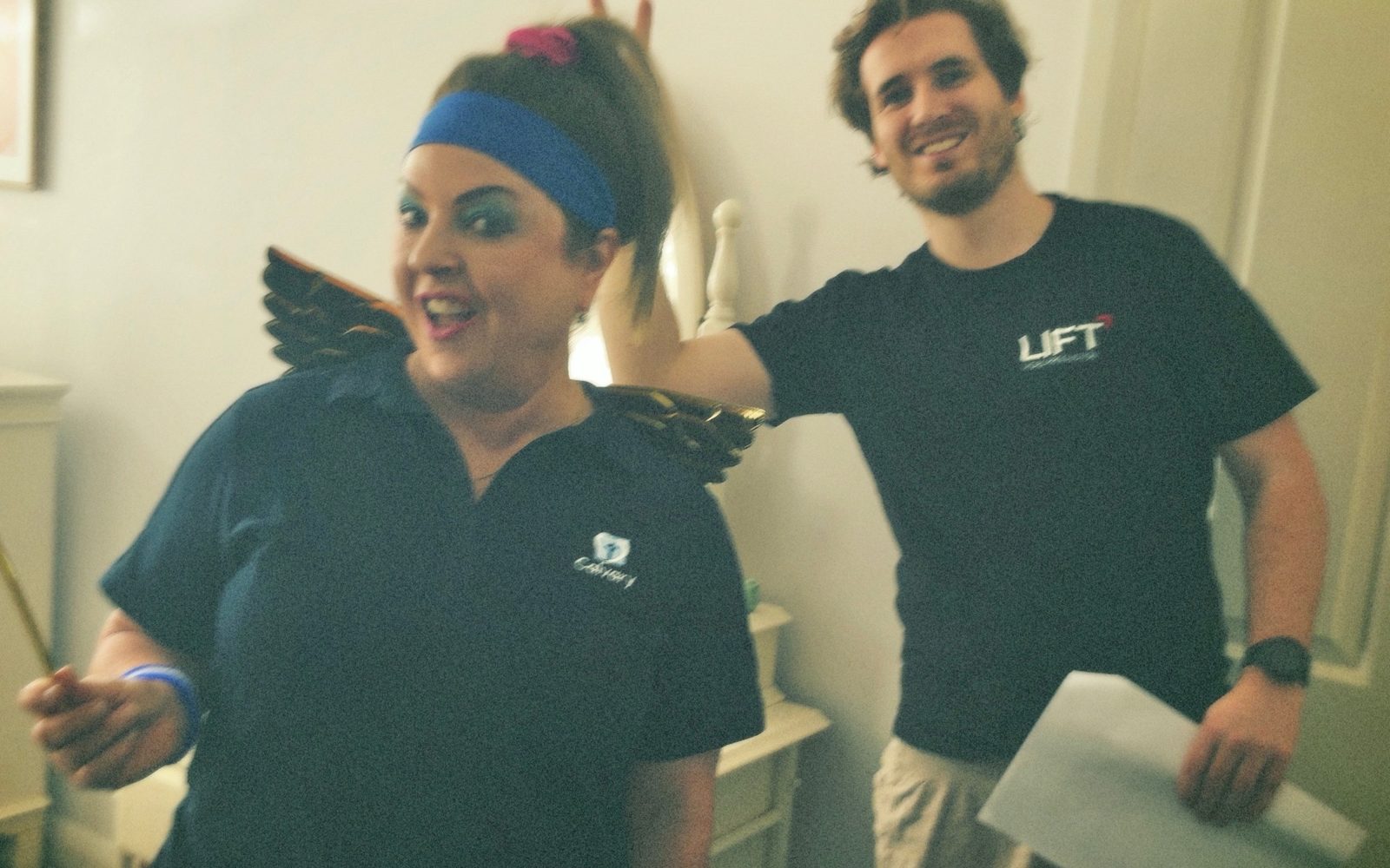 A Lift crew member laughing with the Fitness Fairy performer on the Calvary shoot