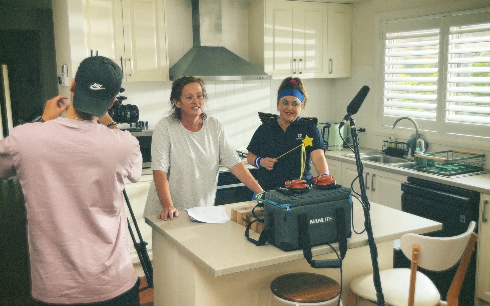 Lift filming a home care scene with two performers in a kitchen for Calvary