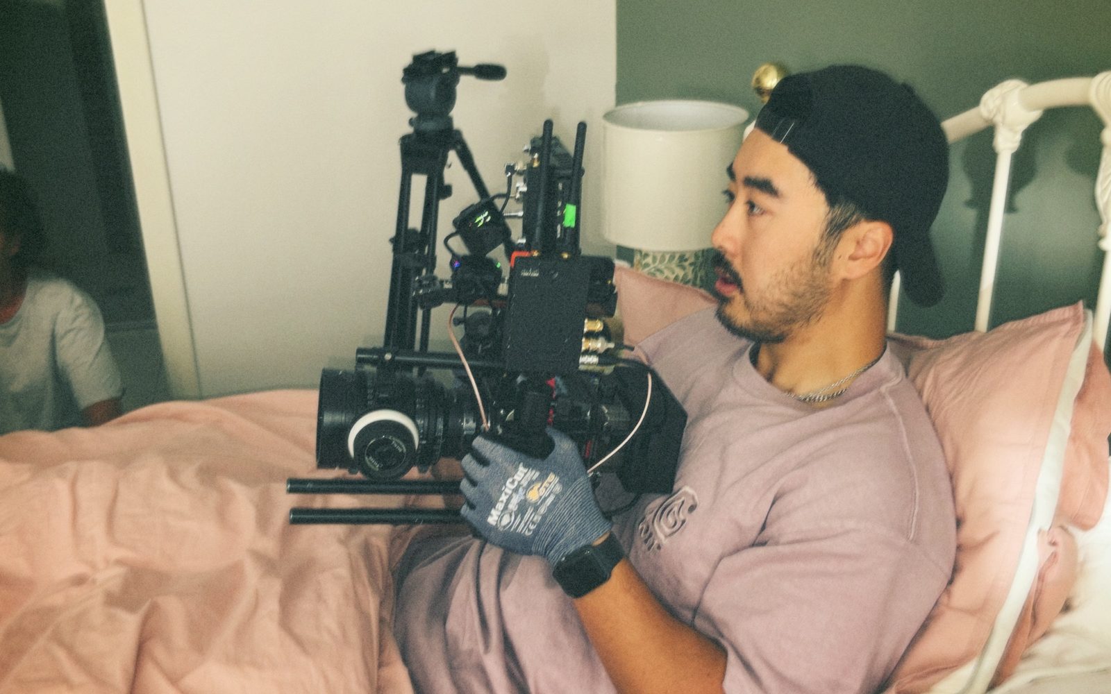 A Lift cinematographer lying in a bed with the camera to film a point of view shot for Calvary