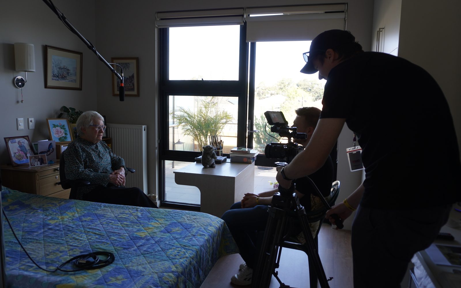 A small Lift crew filming a resident in her room at a Mayflower aged care home