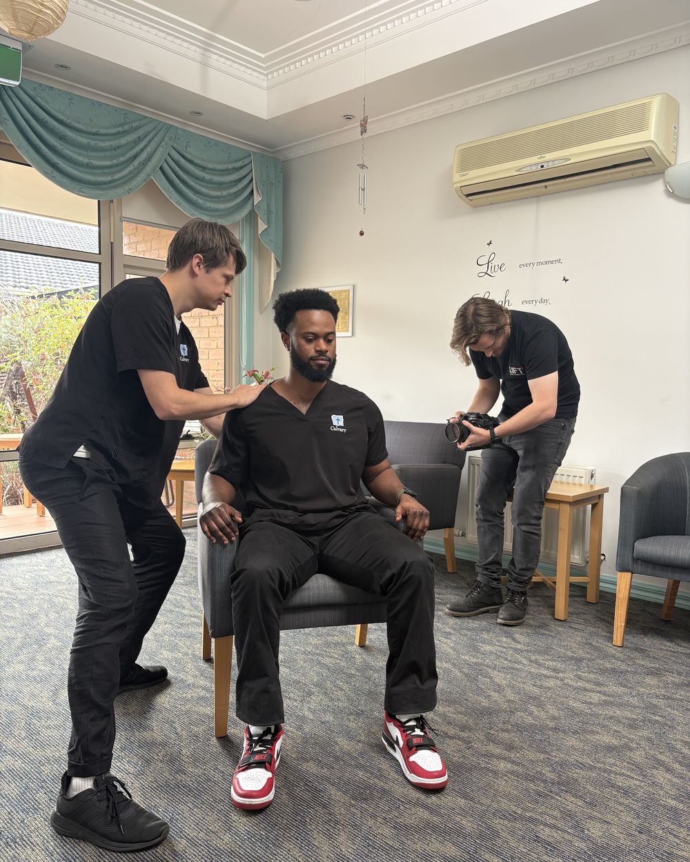 Setting up a seated interview in an aged care lounge