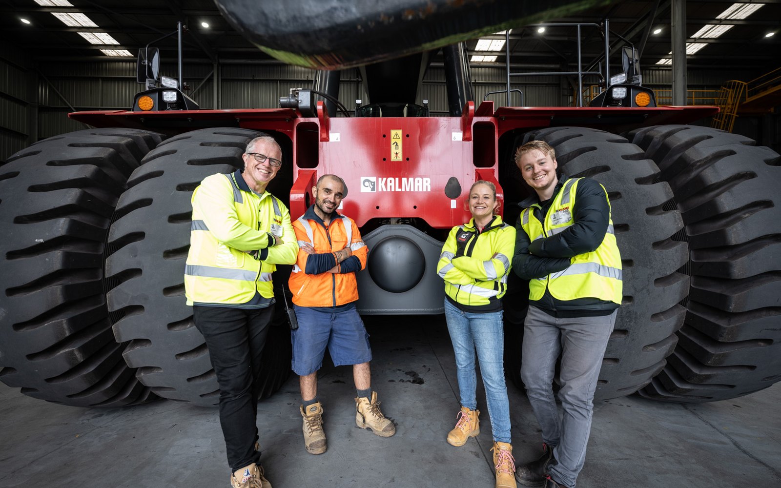 The Lift crew with a Kalmar operator in front of a reach stacker