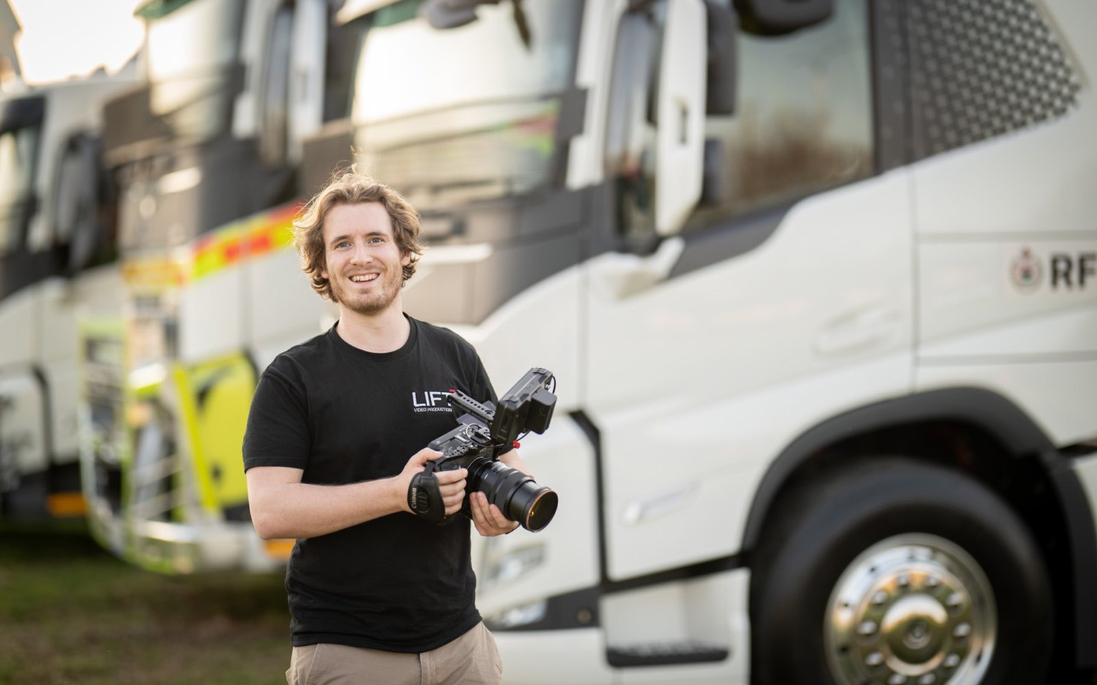 Paddy from Lift with a camera in front of a Volvo electric truck in Rural Fire Service livery