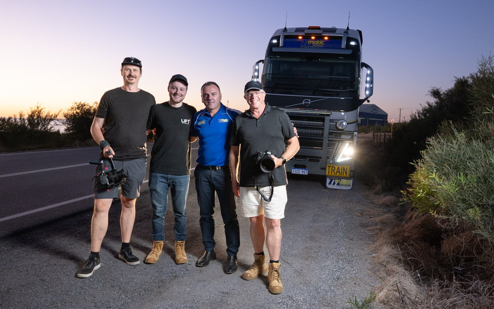 The Lift crew with Danny Matic of Matic Transport in front of a Volvo prime mover at dusk